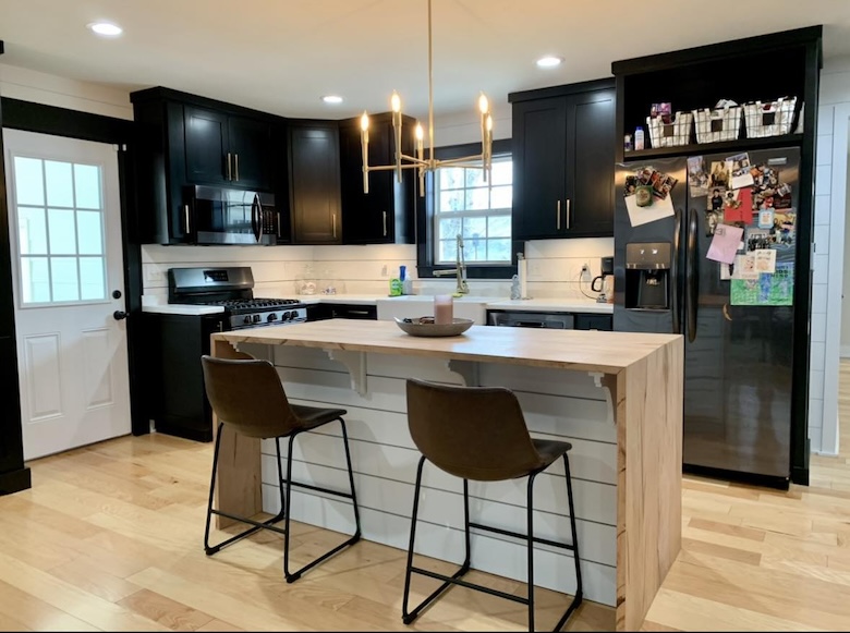 Photo of pantry area with open shelves, white marble countertops and white lower drawers