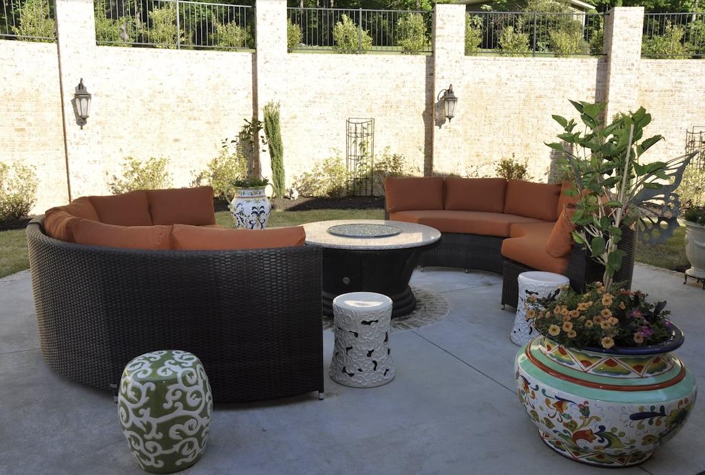 Photo of patio with large square tiled floor and privacy wall on exterior of yard